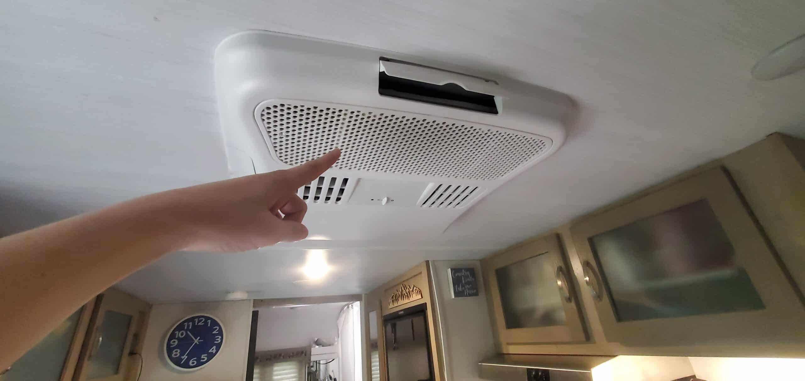 Finger pointing at rooftop RV AC filter