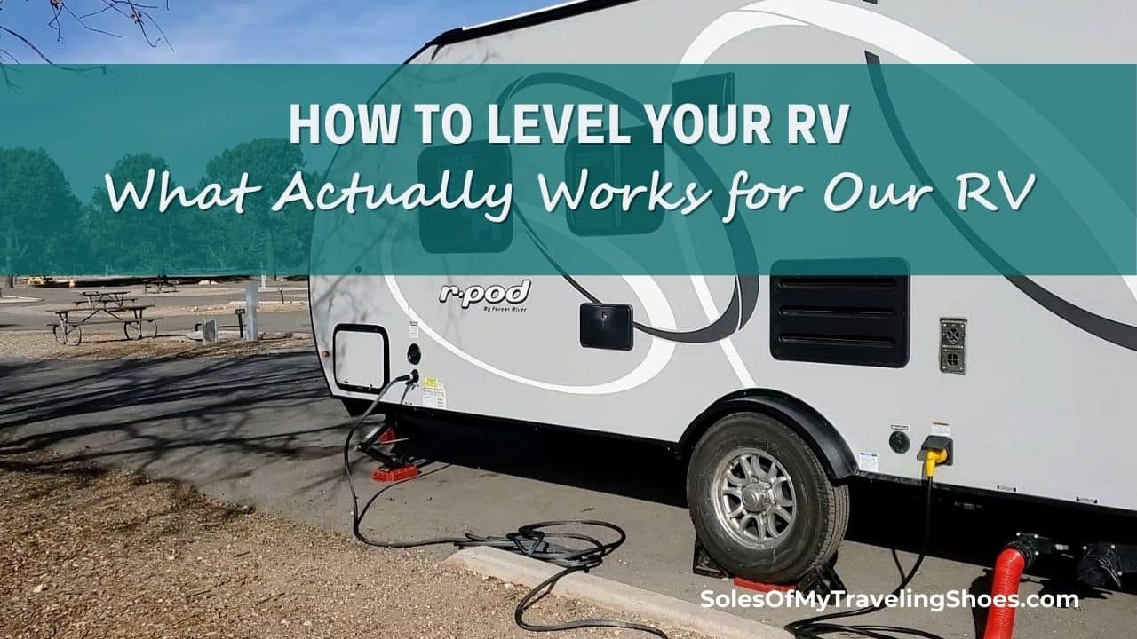 How to level your RV -showing rv with level blocks under wheel and stablizer